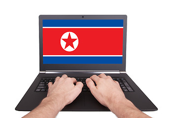 Image showing Hands working on laptop, North Korea