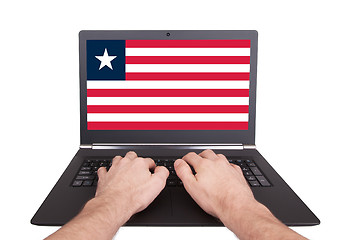Image showing Hands working on laptop, Liberia
