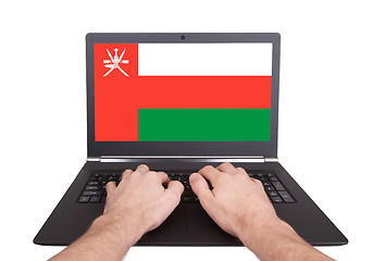 Image showing Hands working on laptop, Oman