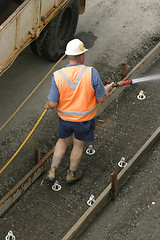 Image showing Construction Worker Useing a Hose