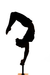 Image showing caucasian woman contortionist practicing gymnastic yoga in silhouette