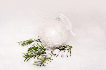 Image showing Christmas ball and fir branch with snow