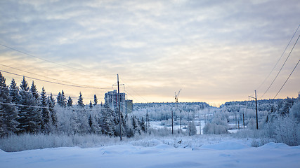 Image showing Snowy road, forest and construction site on winter landscape