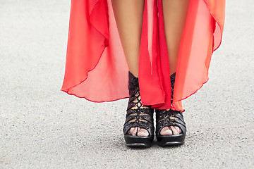 Image showing Slender woman legs on heels and red dress 