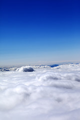 Image showing Mountains under clouds and clear blue sky