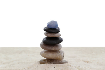 Image showing Balanced pebbles on sand