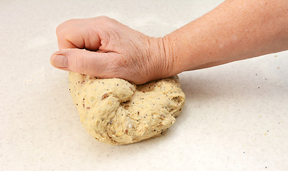 Image showing Woman kneading bread dough by hand