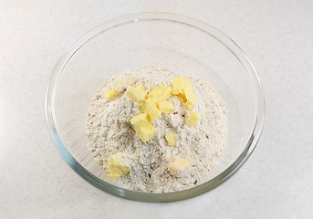 Image showing Adding butter to a bread mix