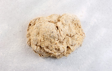 Image showing Rough ball of bread dough on a floured work surface