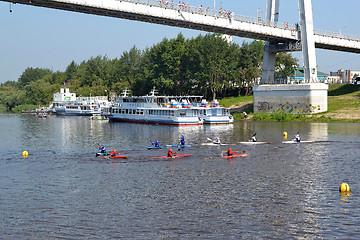 Image showing People on kayaks and Tyumen-2 motor ships under the foot bridge 