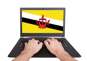 Image showing Hands working on laptop, Brunei