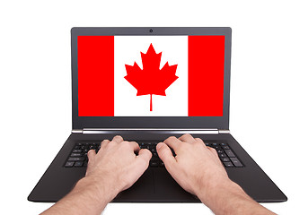 Image showing Hands working on laptop, Canada