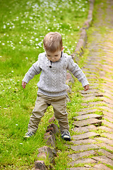 Image showing Trendy 2 years old baby boy playing in park