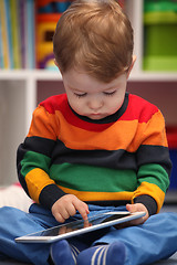 Image showing Happy 2 years old boy using a digital tablet computer