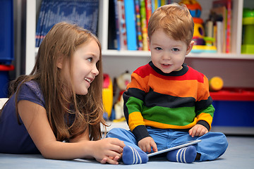 Image showing Girl with her little brother fun using a digital tablet computer