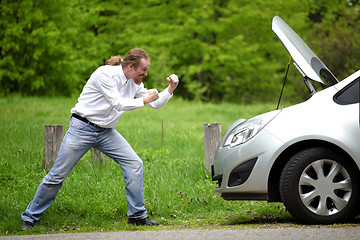 Image showing Driver furious a broken car by the road  