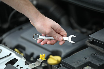 Image showing Auto mechanic with iron spanners in closeup