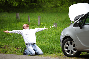 Image showing Driver furious a broken car by the road  