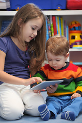 Image showing Girl with her little brother fun using a digital tablet computer