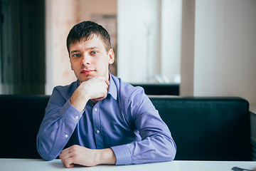 Image showing Handsome Thinking Man In Shirt Sitting In Cafe