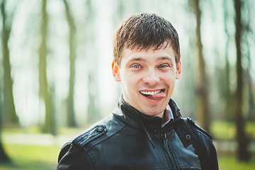 Image showing Close Up Young Handsome Man Shows Tongue. 