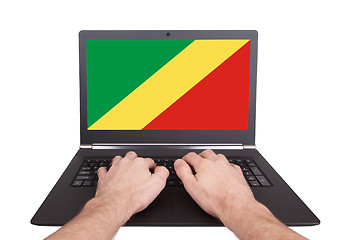 Image showing Hands working on laptop, Conga