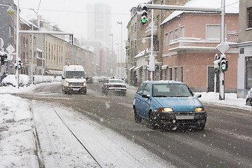 Image showing Snowy winter road with cars driving