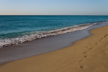 Image showing Footsteps on a golden, sandy beach