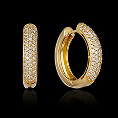 Image showing Gold diamond earrings isolated on black background