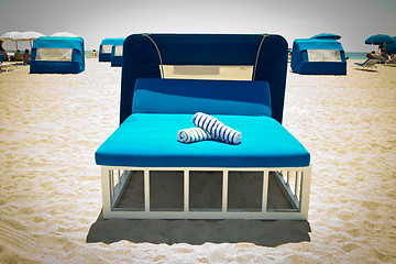 Image showing Luxurious beach bed with canopy on a sandy beach