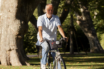 Image showing Senior Man Riding Bicycle