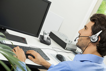 Image showing Man wearing headset giving online chat and support