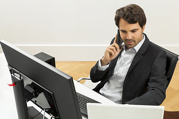 Image showing Successful businessman working in his office