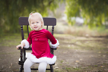 Image showing Adorable Little Girl Sitting in Her Chair Outside