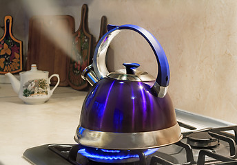 Image showing Kettle of boiling water on the flame of the gas stove.