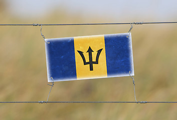 Image showing Border fence - Old plastic sign with a flag