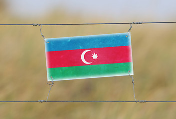 Image showing Border fence - Old plastic sign with a flag