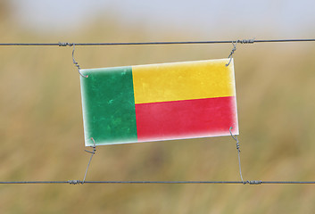 Image showing Border fence - Old plastic sign with a flag