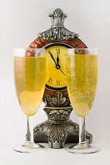 Image showing Clock and two tall wine glass