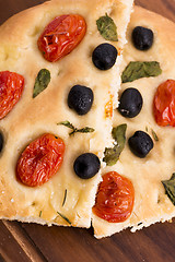 Image showing Focaccia with black olives, tomatoes and basil