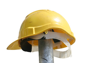 Image showing Hard hat resting on a  pole