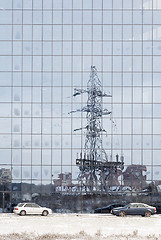 Image showing electric pole reflected in windows of office building 