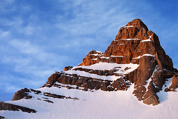 Image showing Snowy sunlight rocks at sunrise