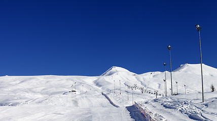 Image showing Winter mountains and ski slope at nice sun day