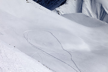 Image showing View on snowy off piste slope with trace from ski and snowboards