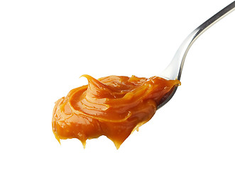 Image showing Spoon of melted caramel cream