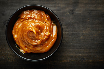 Image showing Bowl of melted caramel cream