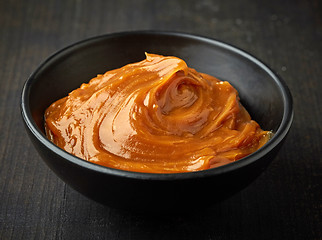 Image showing Bowl of melted caramel cream