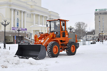 Image showing The bulldozer occupied with snow cleaning is on the square near 