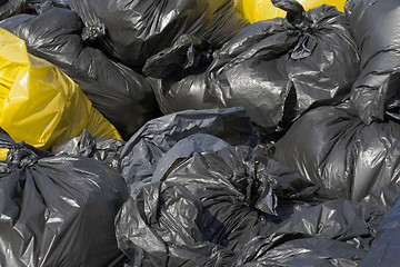 Image showing Black and yellow garbage bag 
